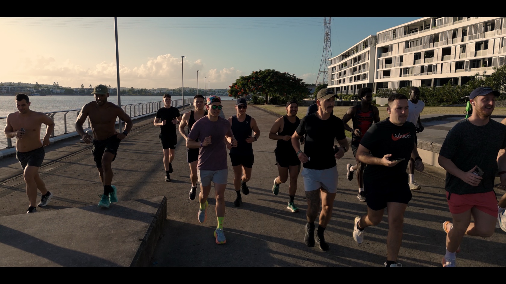 Men running together along the Brisbane waterfront